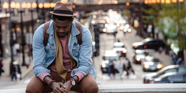 anxious man sat down in the city looking down anxiety symptoms