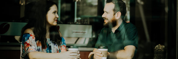 @christinhume Man and Woman having coffee in cafe window, smiling couple