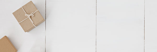 brown paper wrapped gifts on a white table