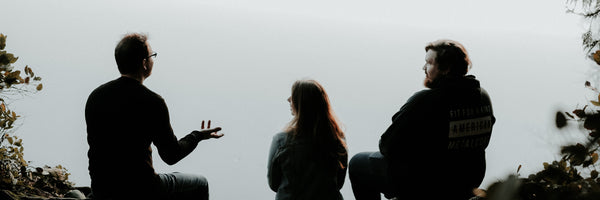 three people talking looking at a view
